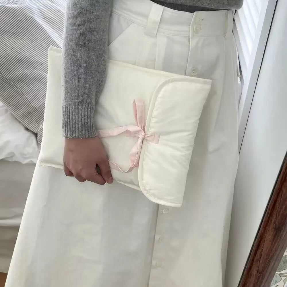 Black and white quilted nylon laptop bag for women with a ballet bow and striped pattern.