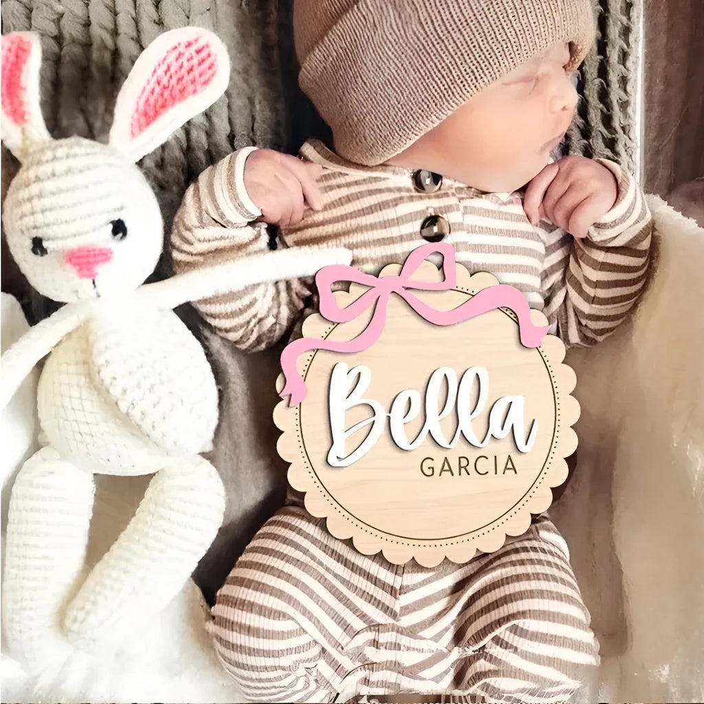 Customised square wooden baby ornament with a name for birthday or holiday decoration.