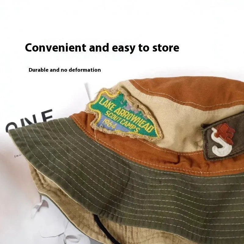 Army green cotton fisherman hat with flat top crown and hand-painted patchwork details, shown folded and unfolded