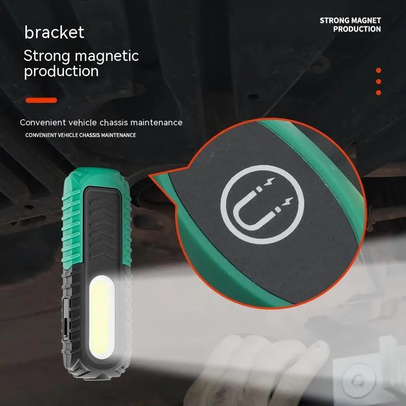 Black and green auto repair work light with USB charging cable for vehicle maintenance