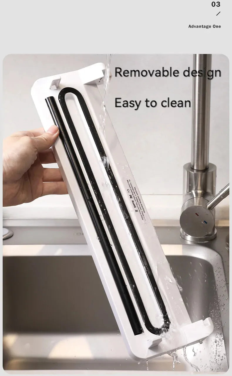 White automatic vacuum sealer machine on a kitchen countertop.