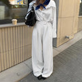 White striped women's wide-leg trousers with zip fastening and loose casual fit