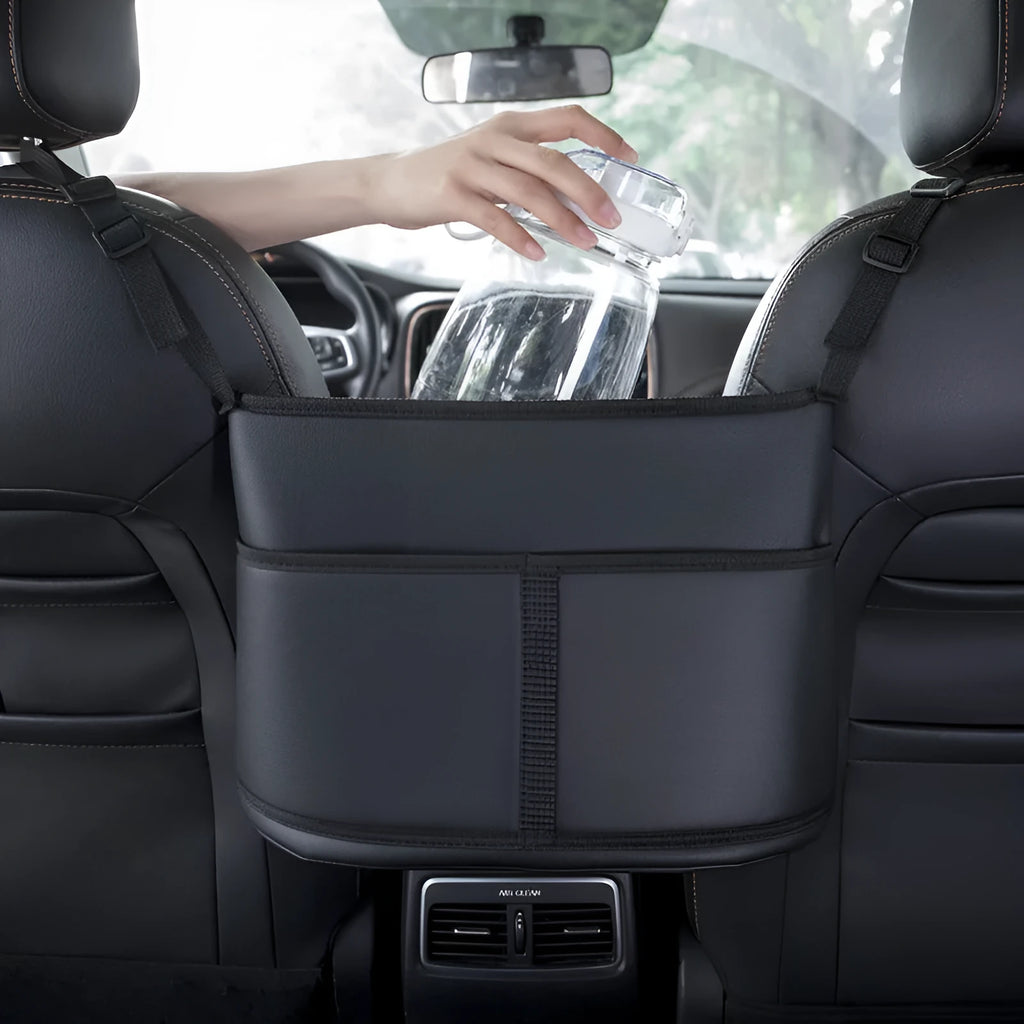 Black leather car seat net pocket storage bag with sports carbon fibre pattern placed between vehicle seats