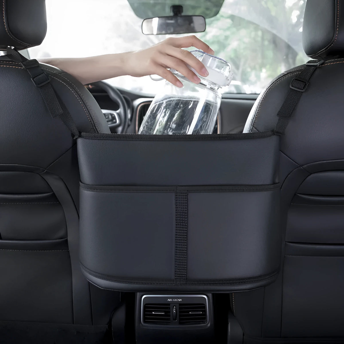 Black leather car seat net pocket storage bag with sports carbon fibre pattern placed between vehicle seats
