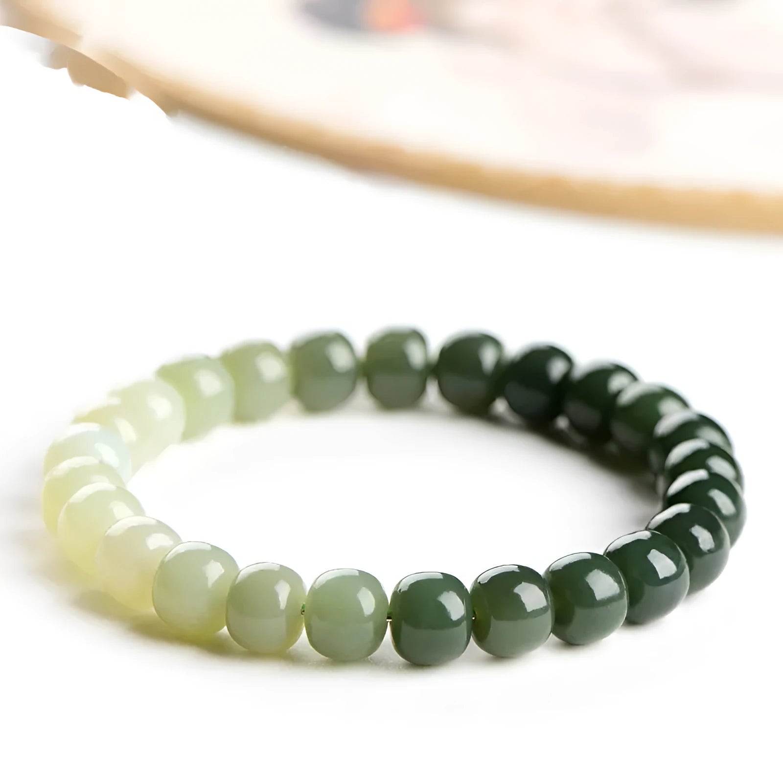 Natural Hetian jade bracelet showing water gradient colour on polished beads