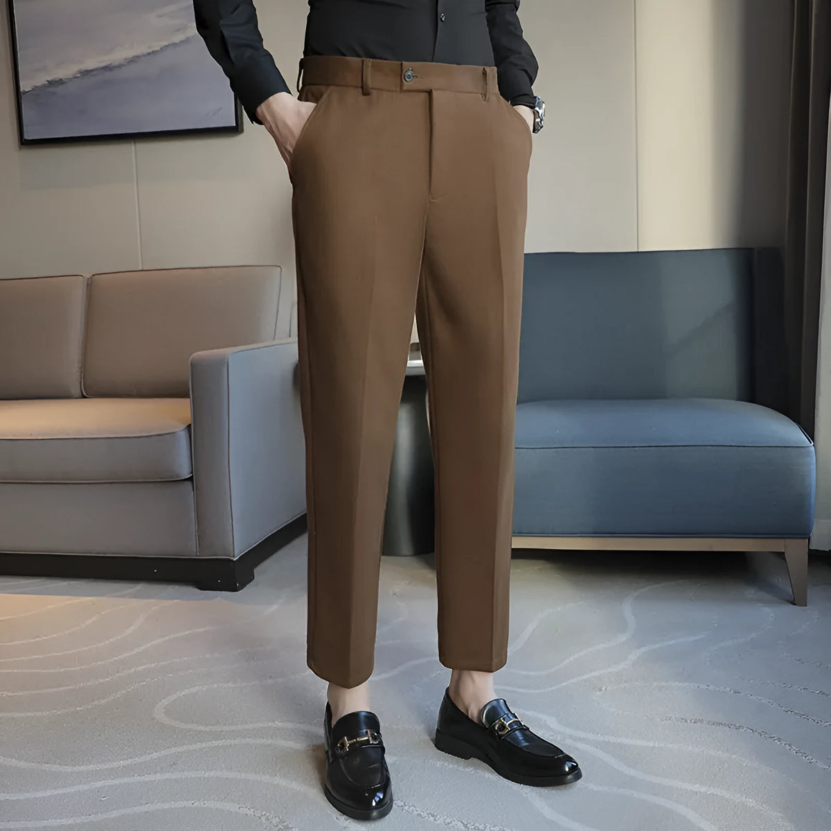 Brown straight leg corduroy trousers with elastic waistband on hanger