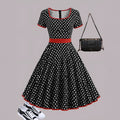 Women's multicolour polka dot dress with square collar, short sleeves, front zipper, and pleated A-line skirt.