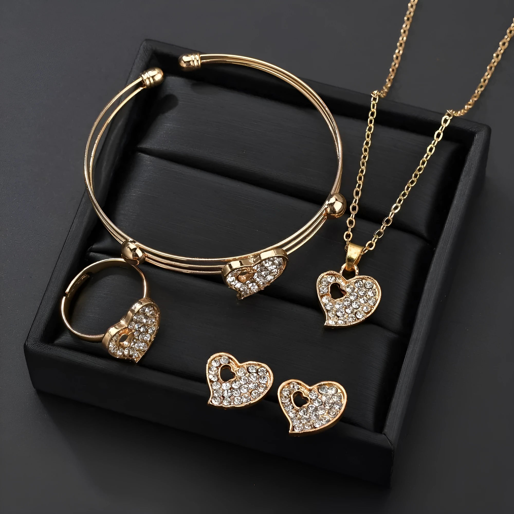 Gold electroplated women's jewellery set with love bell patterns including earrings, pendant and adjustable bracelet