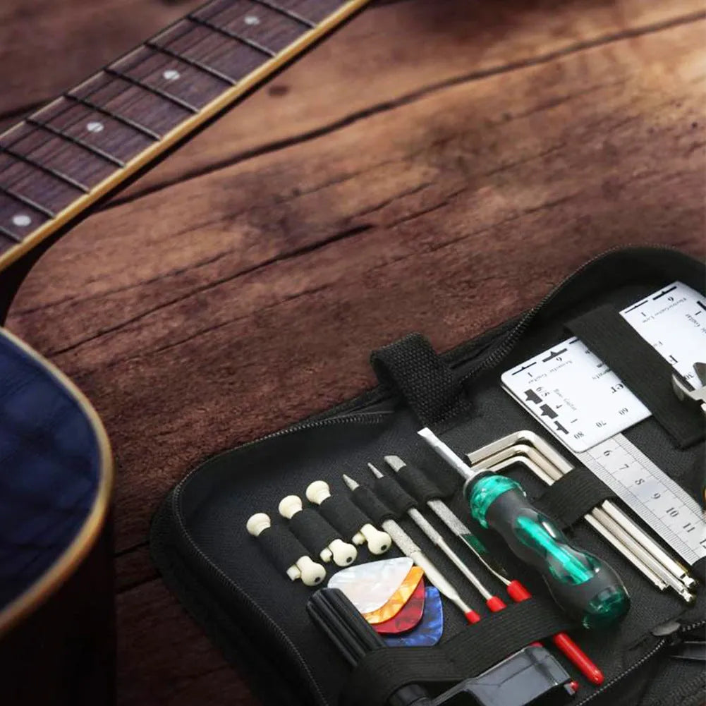 Black plastic case open to reveal a guitar and bass repair tool kit with metal tools for mandolin and banjo maintenance.