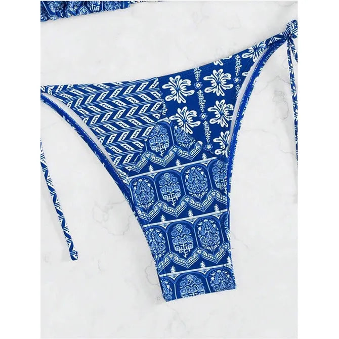 Women's green split bikini bandage swimsuit with printed stitching on a model