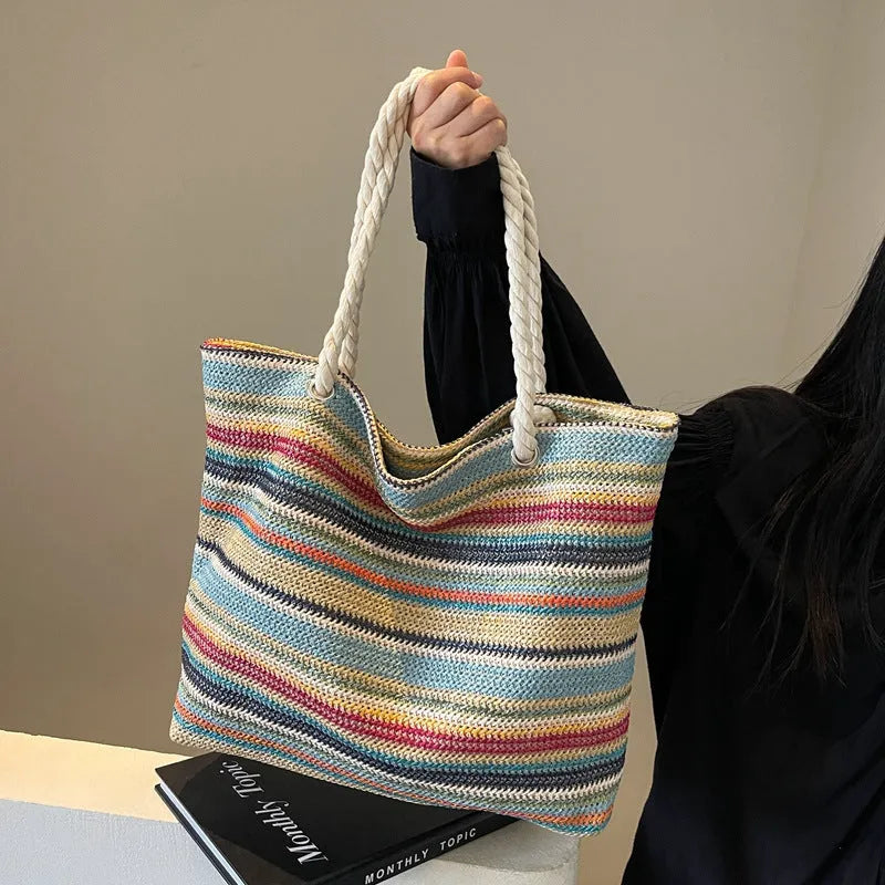 Blue straw woven nylon shoulder bag with a large capacity and polyester lining.