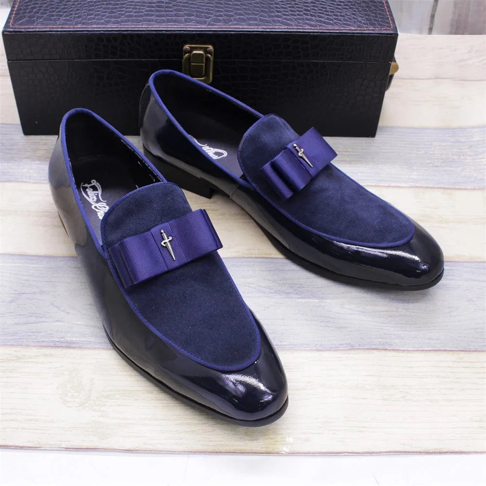 Men's black patent leather dress shoes with a tassel detail and low-top design on a rubber sole.