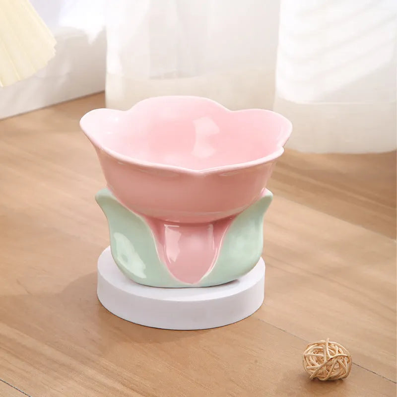 Blue ceramic raised pet bowl with floral pattern and non-slip base for cat or small dog.