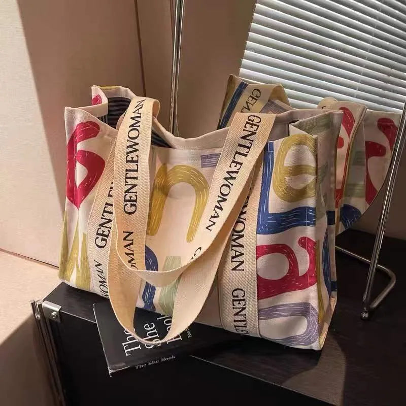 Large canvas tote bag with printed design, shown in available colour and pattern options.