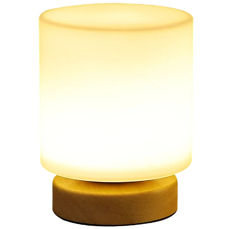 Nordic solid wood USB table lamp in a geometric shape on a wooden surface.