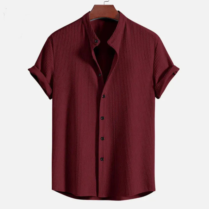 Man wearing a loose-fitting short sleeve polyester shirt in light blue, showcasing the casual summer style.