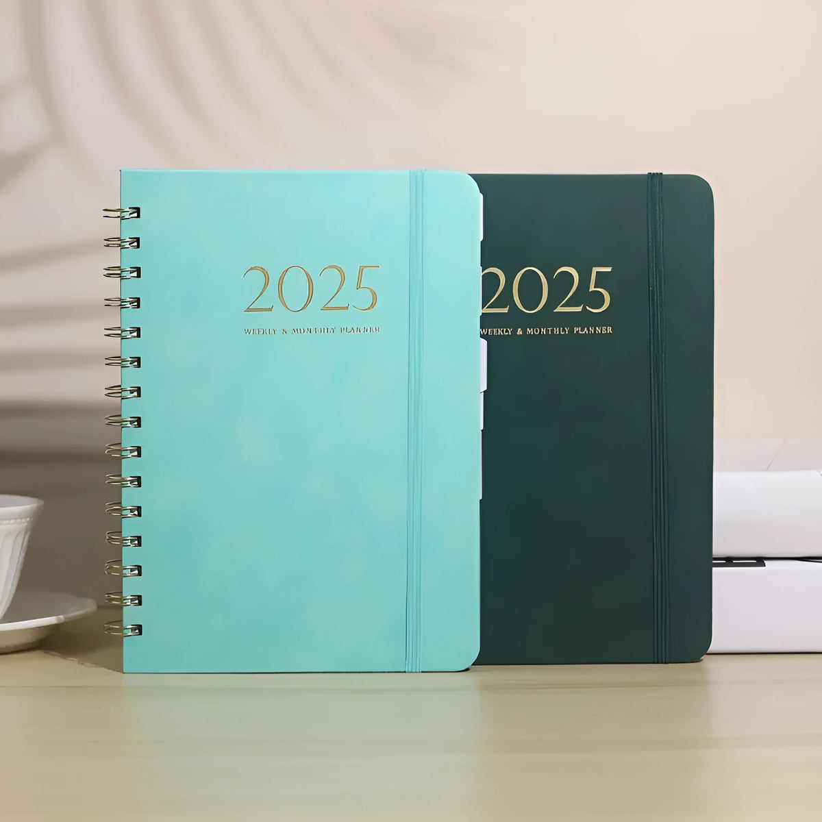A5 size PU leather notebook with metal coil binding in a choice of colours including black, blue, brown, and pink.
