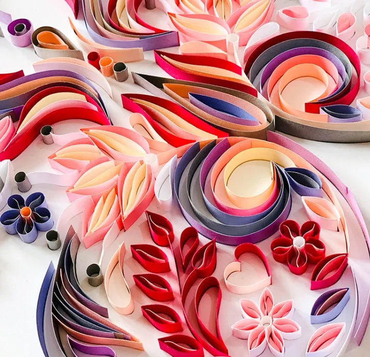 20 inch handmade butterfly quilling paper ornament with craft tools on blue background