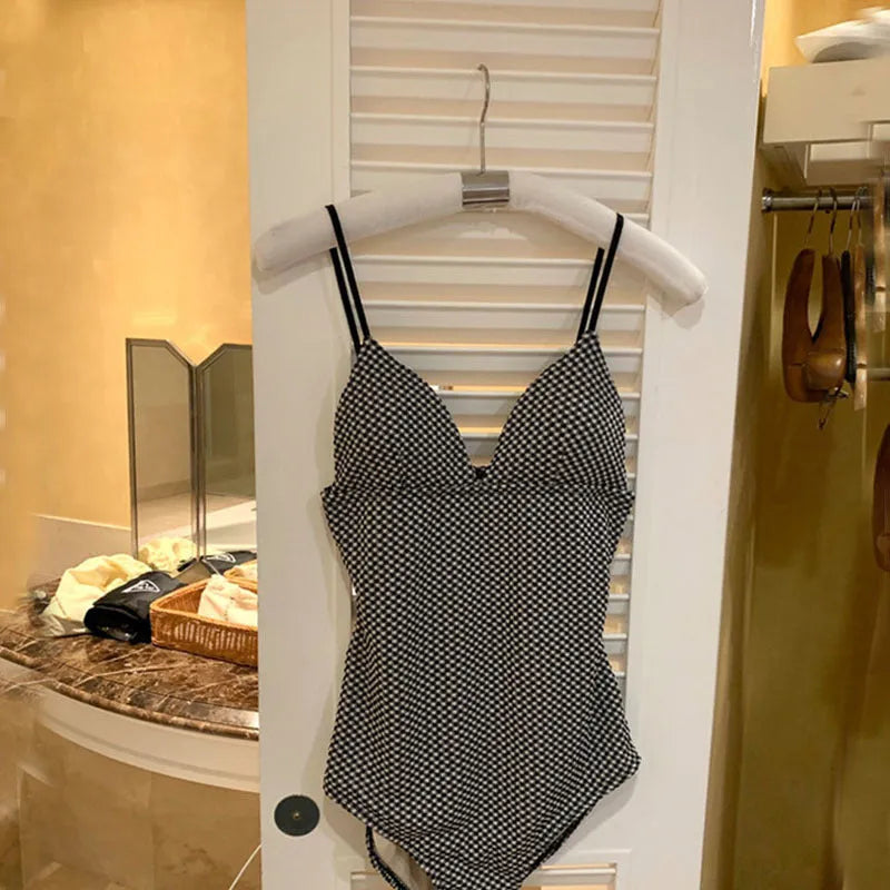 Blue or black one-piece swimsuit for belly and small chest coverage, shown flat.