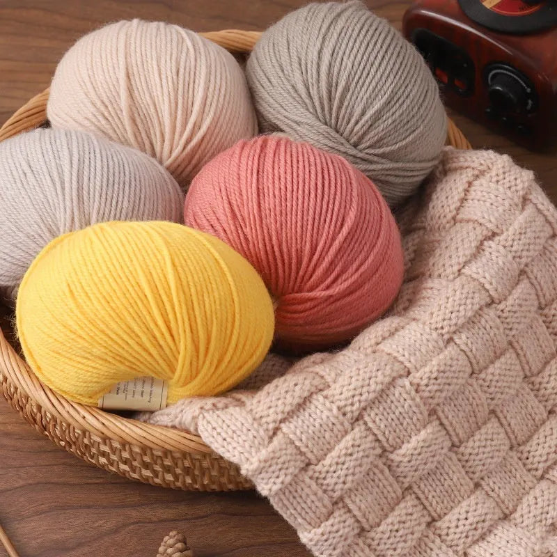 Roll of woolen hand knitting yarn in various colours including autumn fragrance green and bright red