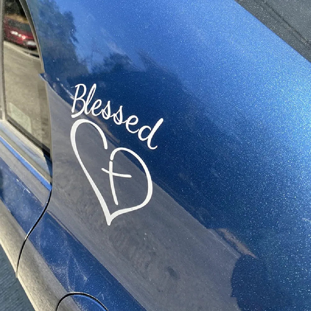 Large red heart-shaped sticker with the words Faith, Hope, Love printed on it.