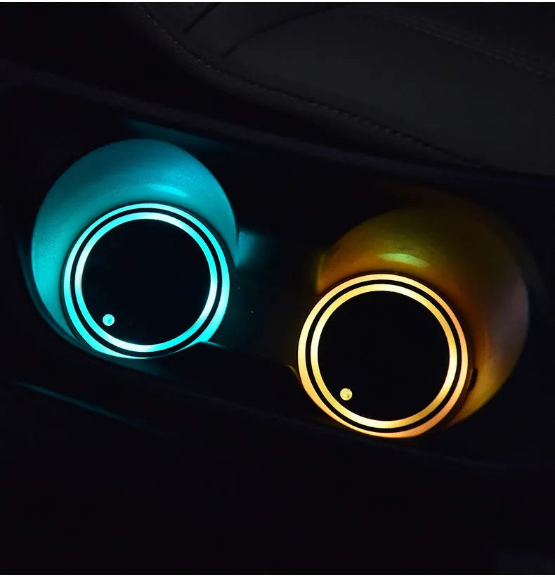 Colourful LED light-up coaster for car cup holder showing multiple light colours on a dark surface.