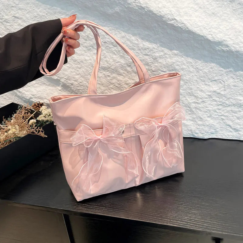 College style bow tote bag in black and pink with large capacity and internal zip compartment