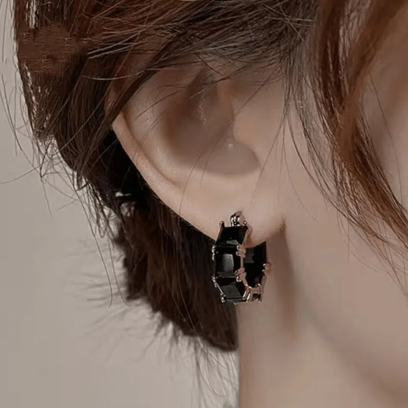 Geometric U-shaped earrings with round crystal zirconium stones in gold setting