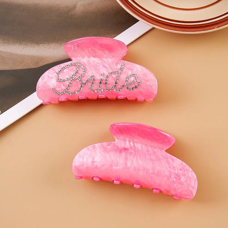 Pink acrylic hair clip with shark shape and diamond spot drilling, 10cm long with spring-clip back.