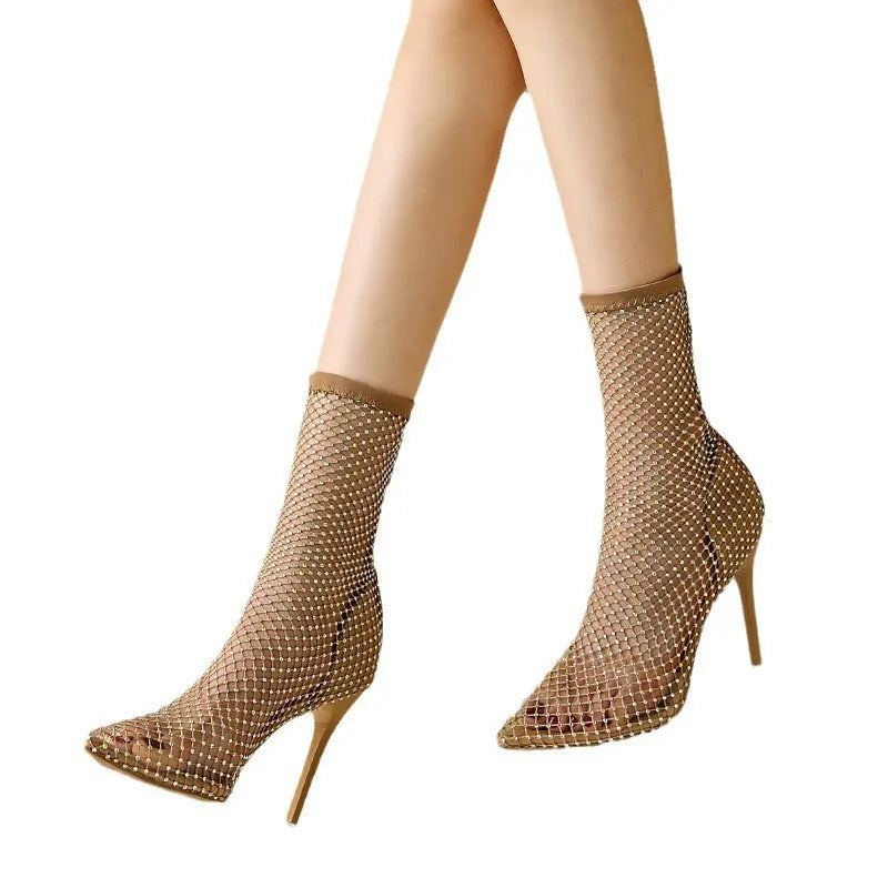 Gold pointed toe stiletto high heel sandals with a mesh upper and oversleeve design.
