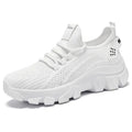 Women's white Flyknit sneakers with thick PVC sole and lace-up front.