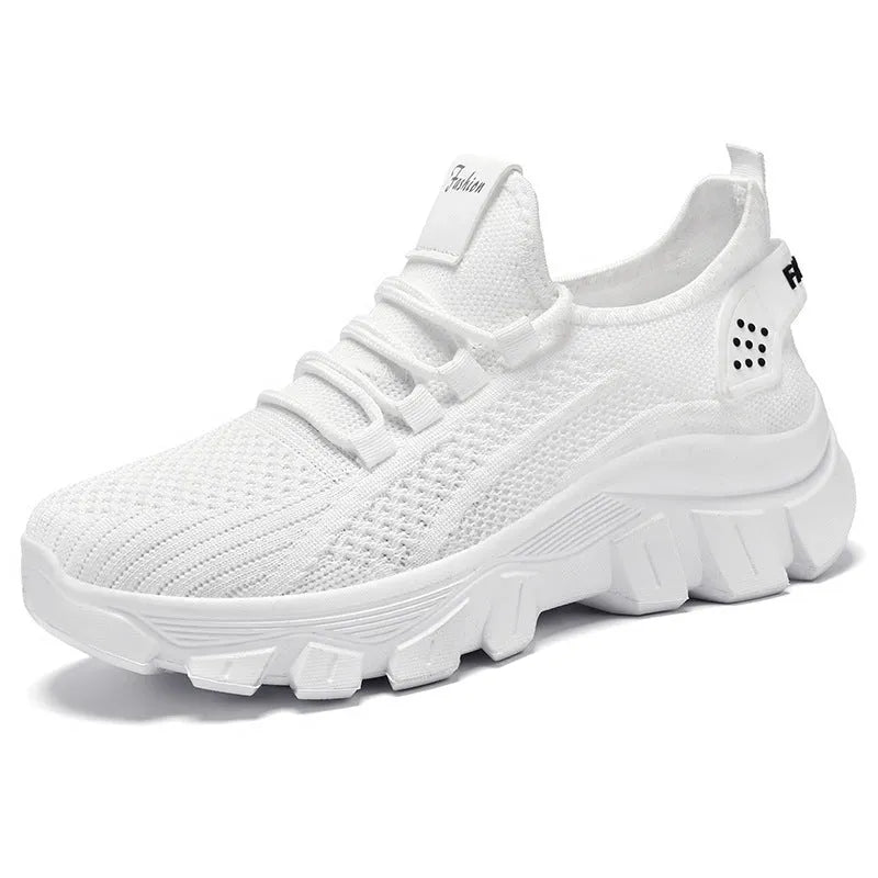 Women's white Flyknit sneakers with thick PVC sole and lace-up front.