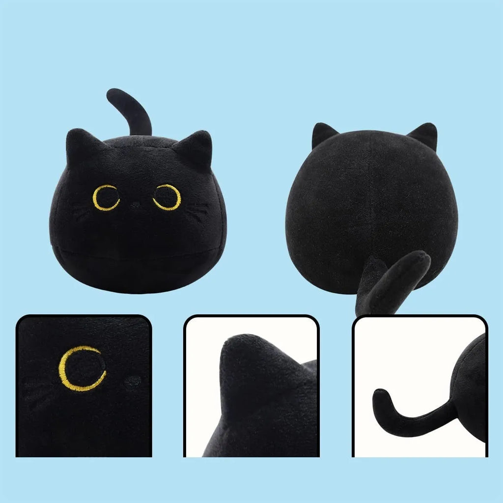 Fluffy black cat stuffed toy with embroidered eyes and whiskers on a grey background.