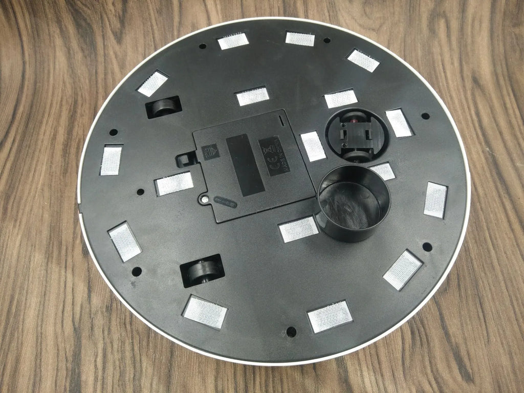 Black or white automatic sweeping robot vacuum cleaner on wooden floor