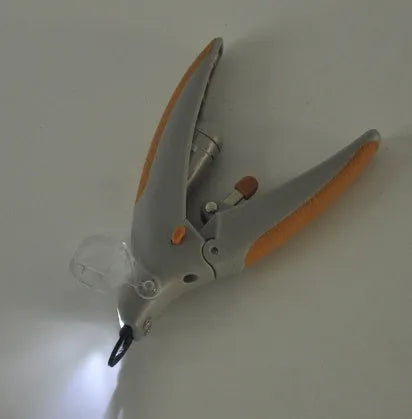 LED dog nail clipper with illuminated tip and visual blood line guide on a white background.