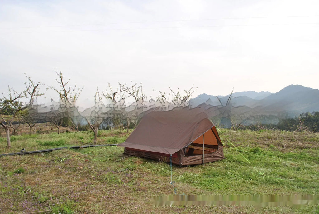 Brown and white pole-free A-line cabin tent set up with hiking canes, showing spacious interior