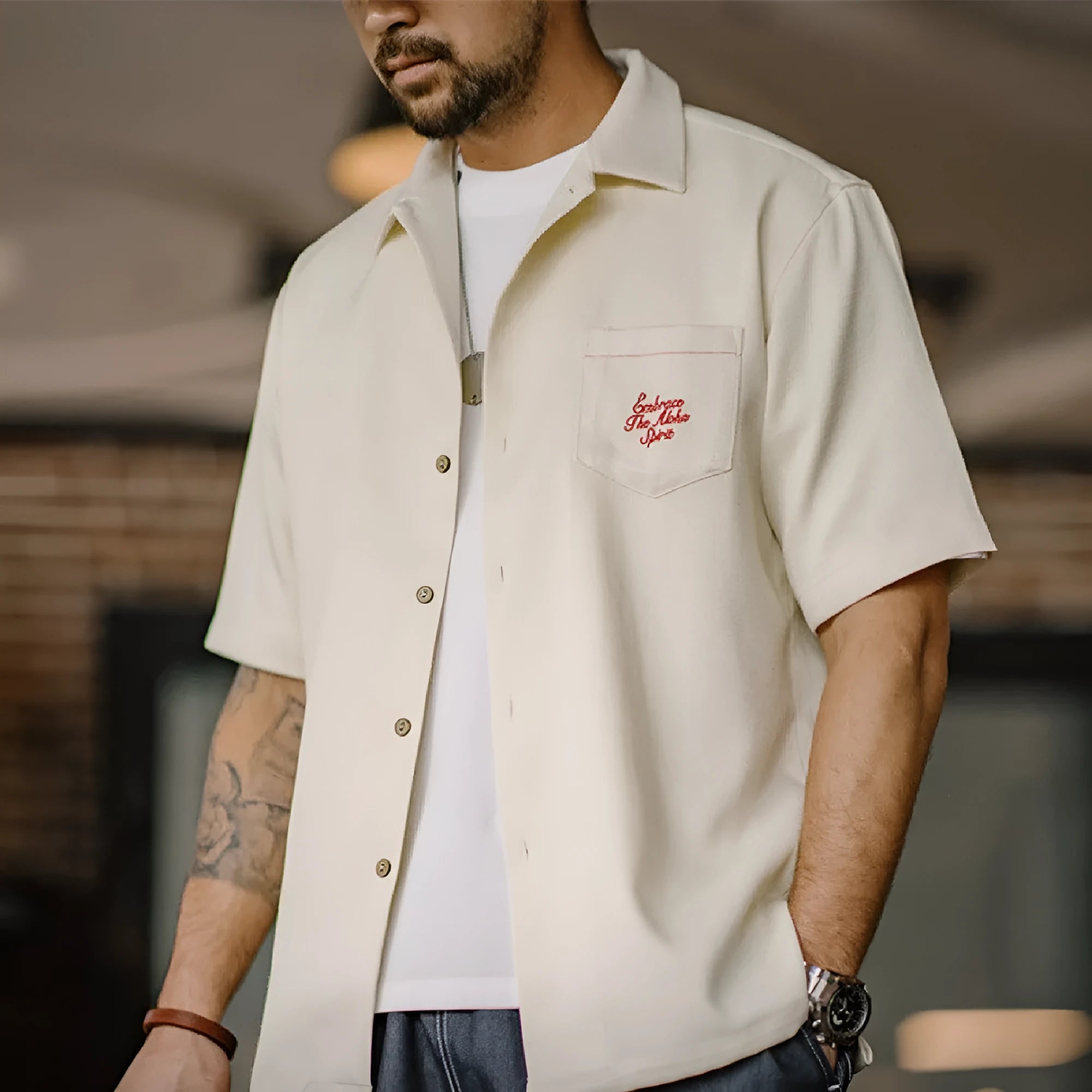 Light apricot men's shirt with bamboo pattern and Cuban collar laid flat.