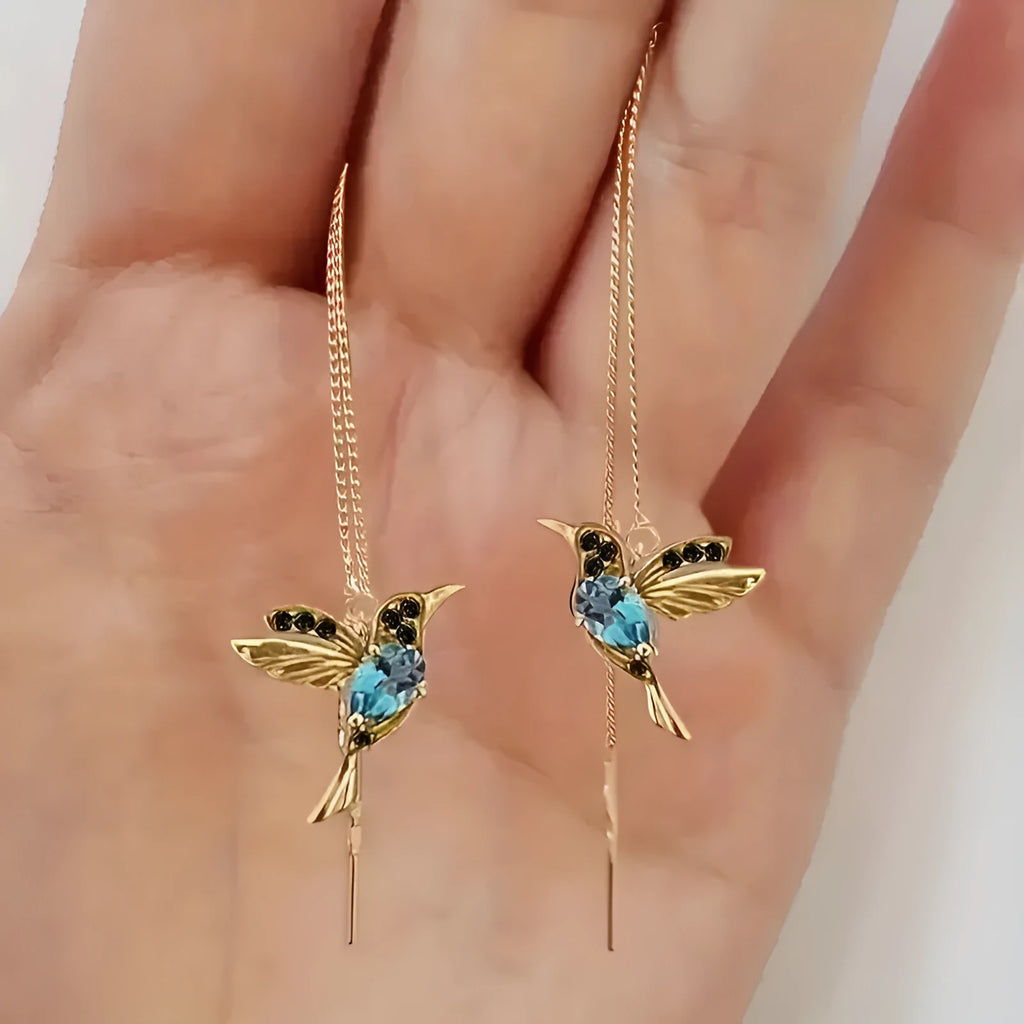Women's long drop earrings with hanging bird pendants and zirconium crystal accents in blue colour option