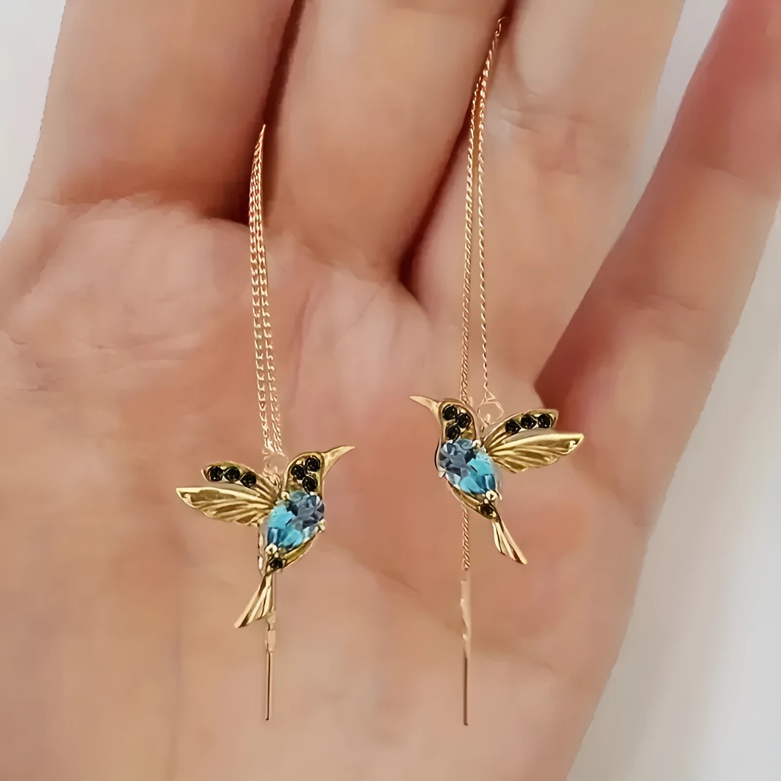Women's long drop earrings with hanging bird pendants and zirconium crystal accents in blue colour option