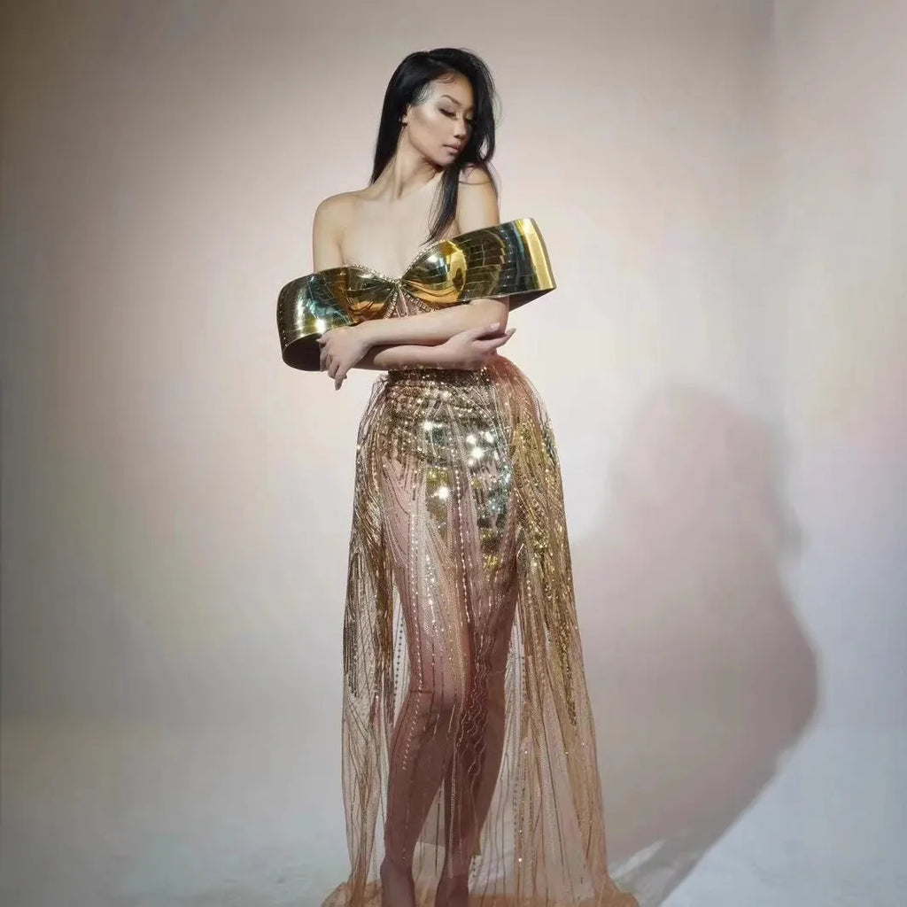 Gold strapless sequined dress with long split skirt on a mannequin