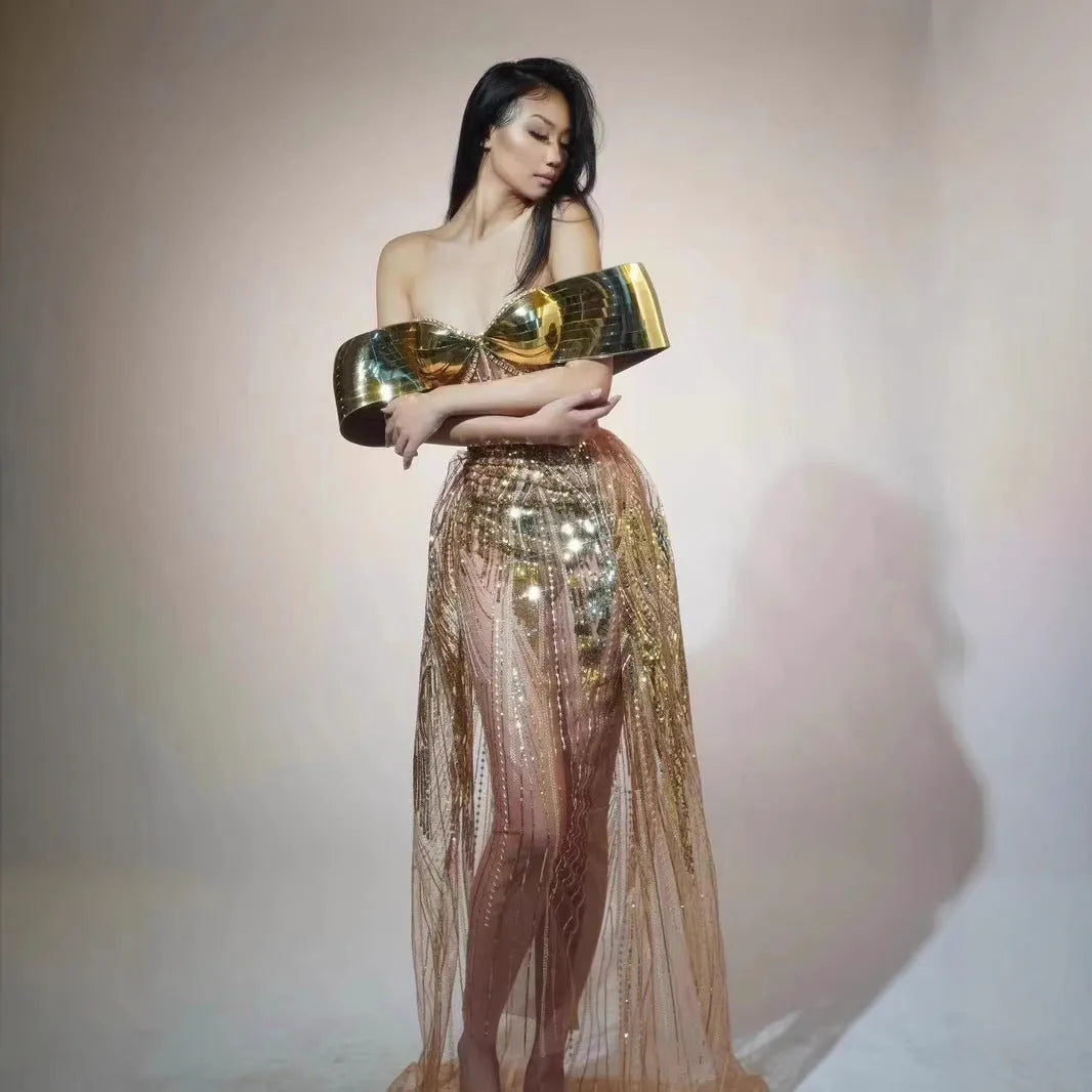 Gold strapless sequined dress with long split skirt on a mannequin