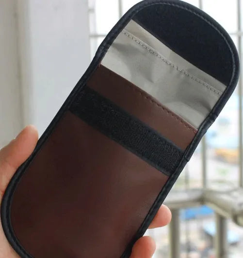 Black microfiber Faraday cage bag for blocking key fob and card signals, shown with dimensions 13.5cm by 9.5cm.