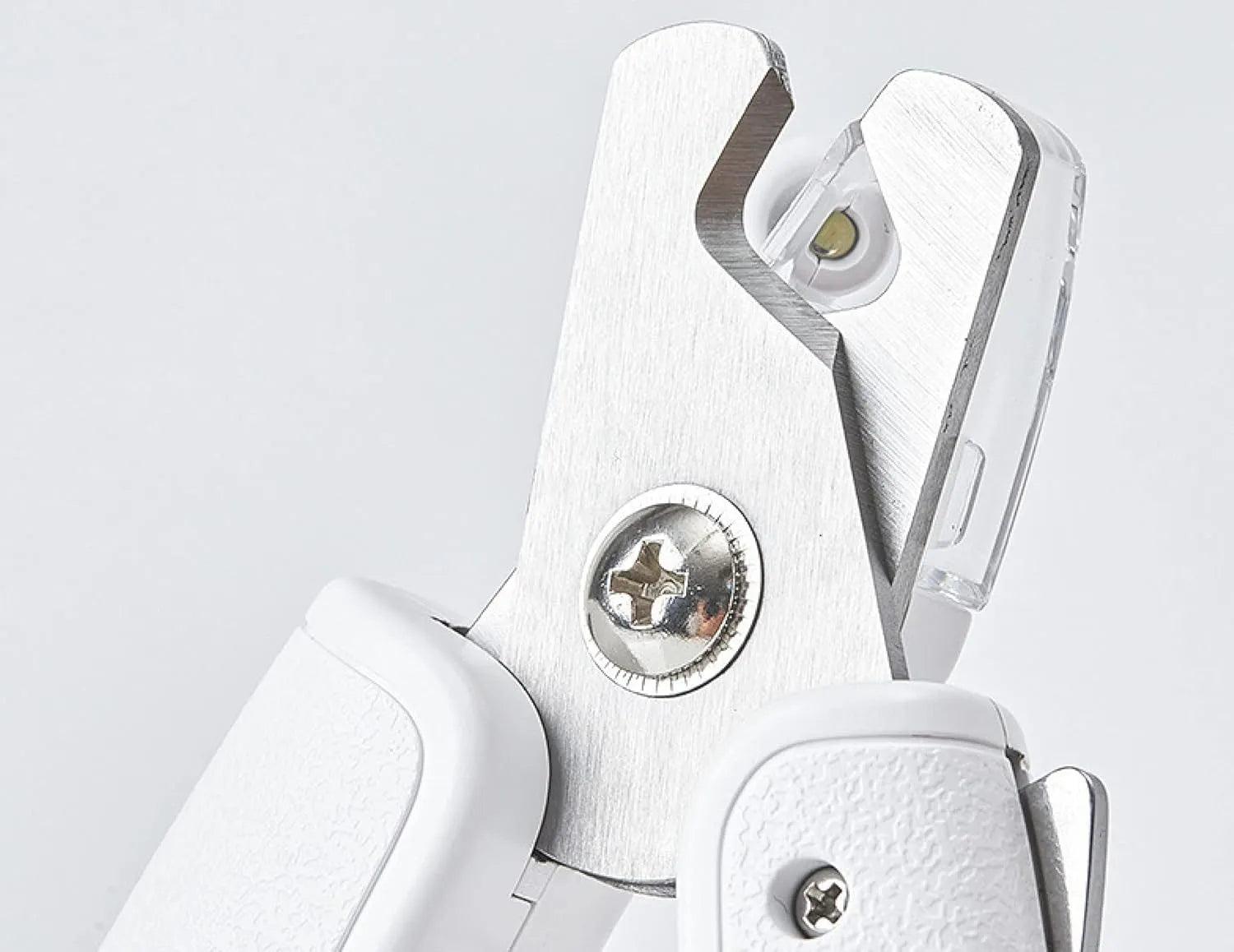 White LED pet nail clippers with transparent guard open, showing triangular steel blades and a nail file.