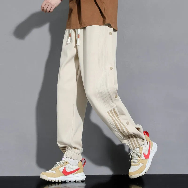 Men's loose fit ankle-tied sports pants in black with drawstring waist and elastic cuffs