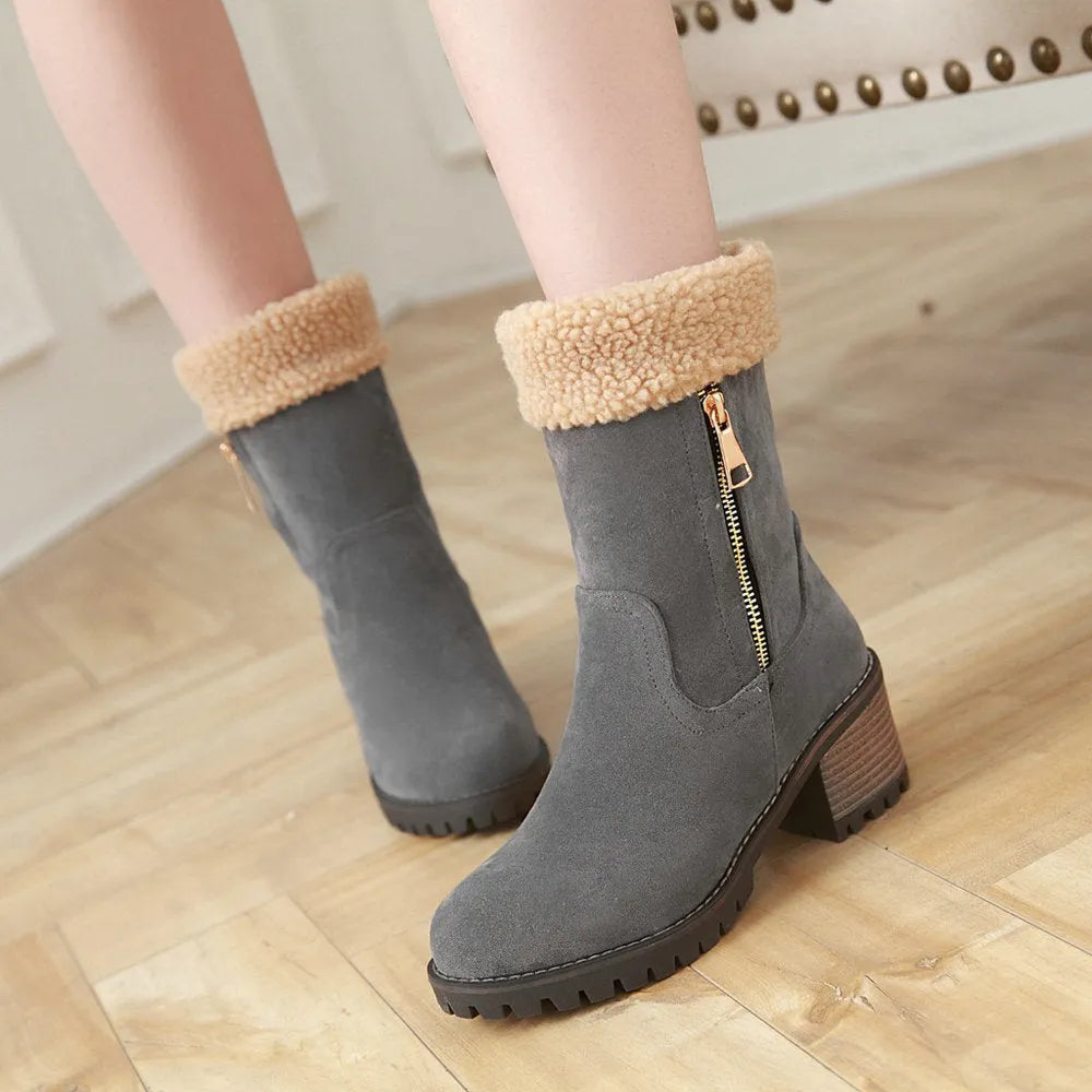 A pair of snow boots in black, shown with a soft plush lining and rubber insole.