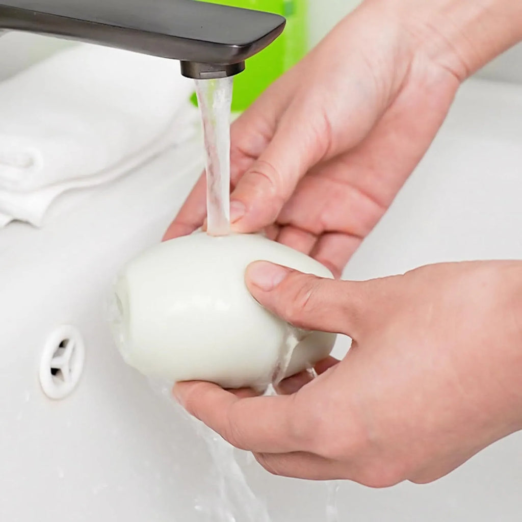 Green and white washable reusable gel lint roller ball for pet hair removal from clothes and furniture