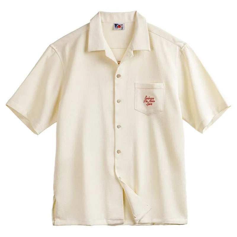 Light apricot men's shirt with bamboo pattern and Cuban collar laid flat.