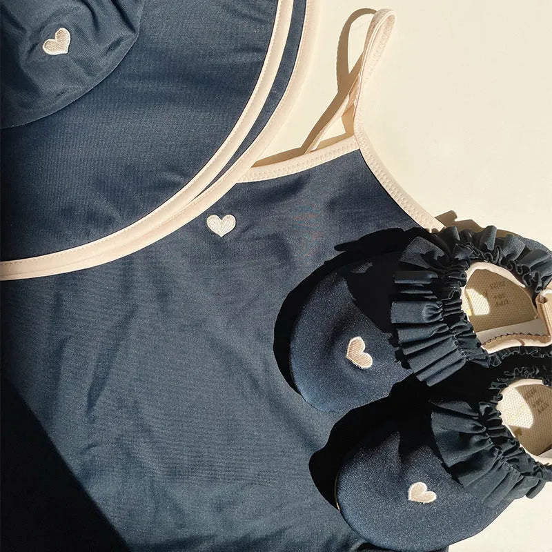 Dark blue girls' split swimsuit briefs made from high elasticity polyester fabric for swimming.