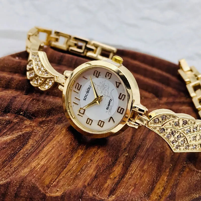 Women's stainless steel watch with round dial and vachette clasp, shown in gold colour.