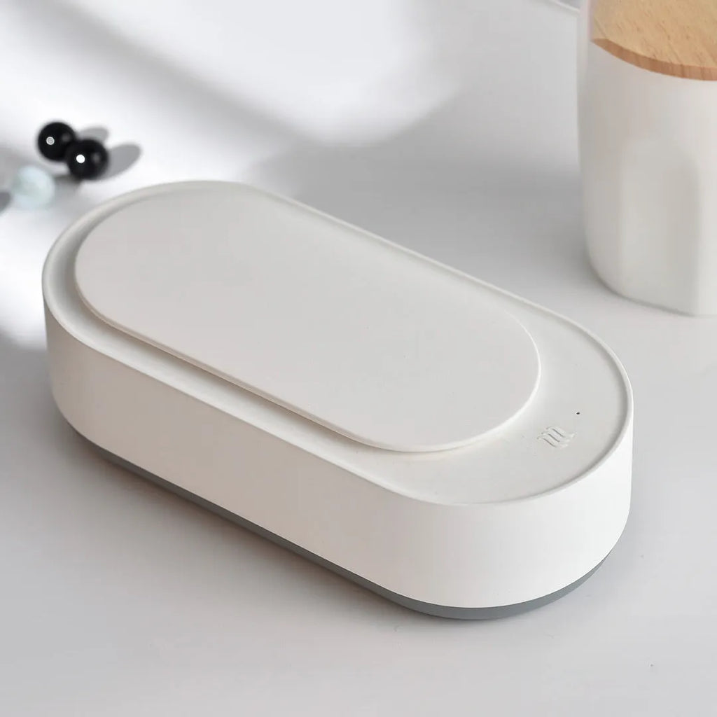 White portable ultrasonic cleaning machine with digital display and stainless steel tank.